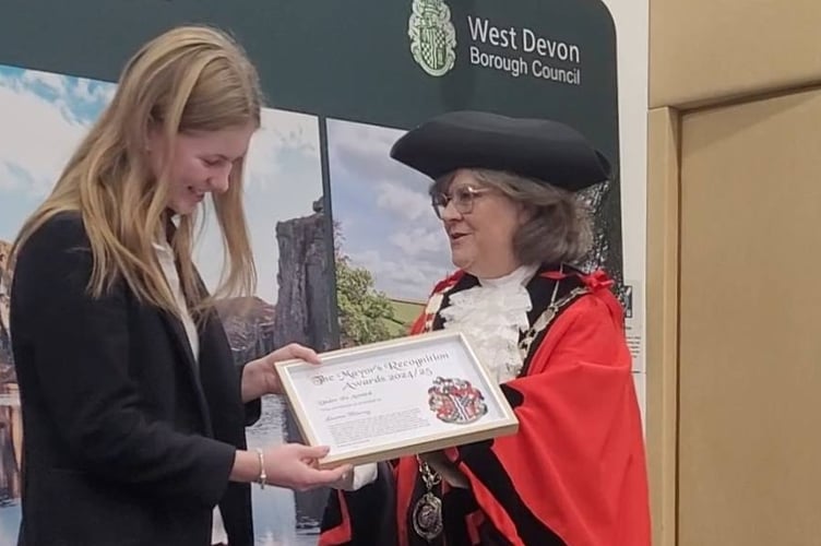 Lauren Blamey (left) receives her mayoral honour from West Devon Borough Council Mayor Debo  Sellis for her fund raising.