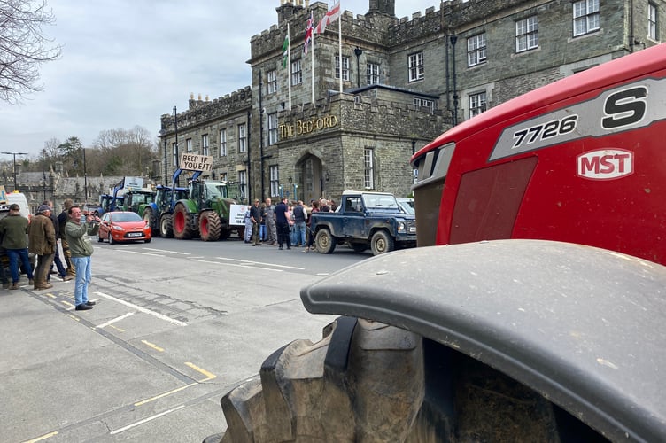A tractor rally and protesting farmers making a noise outside a farming minister's meeting in Tavistock.