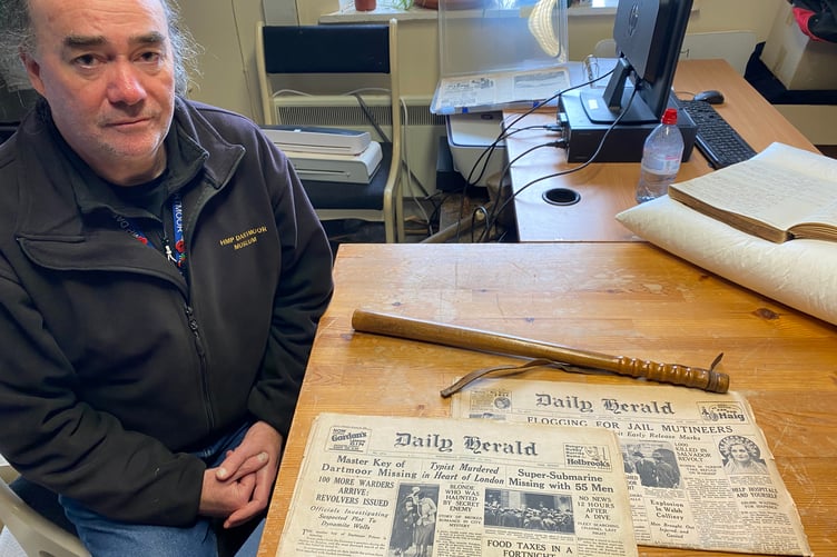 Dartmoor Prison Museum manager Paul Finegan with the newly donated police truncheon used in the 1932 prison riot in Princetown and news reports of the protest.