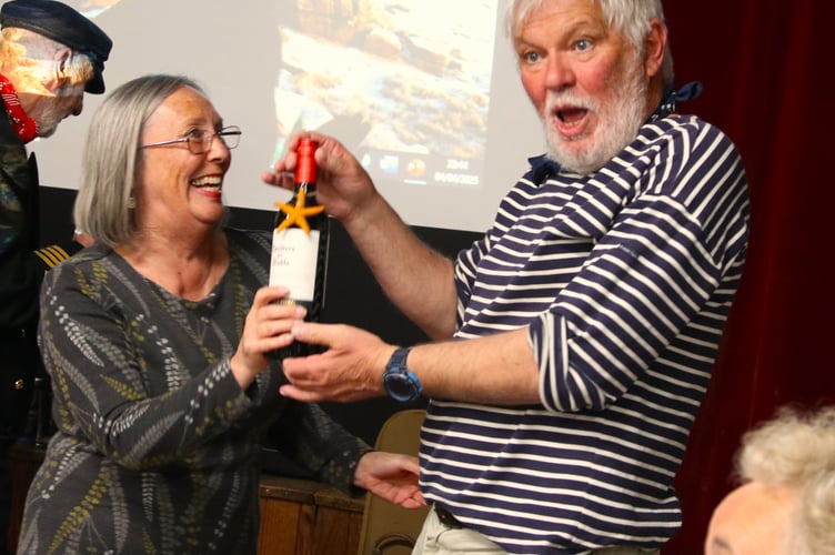 Steve Hipsy of the XX Tars sea shanty group calling the raffle with XX of the Milton Abbot village hall committee. Picture by Chris Cottrell.