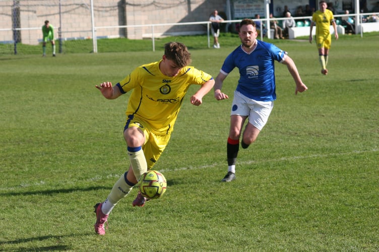 Okehampton Argyle action away at Newton Abbot Spurs