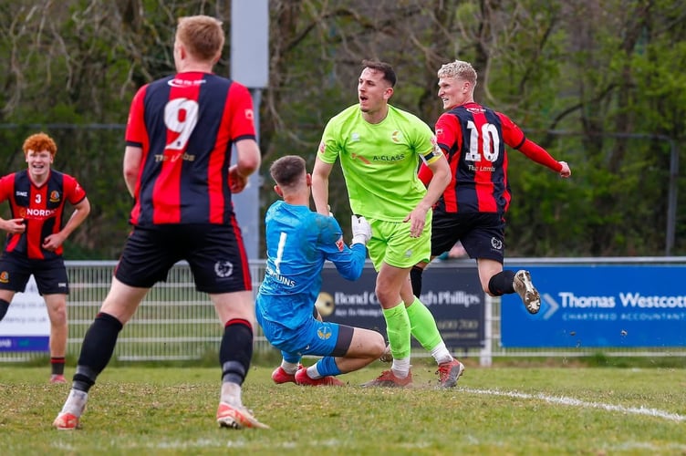 Tyler Elliott wheels away in celebration for Tavistock AFC