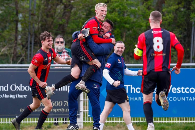 Tavistock AFC manager Stuart Henderson gets involved in the celebrations