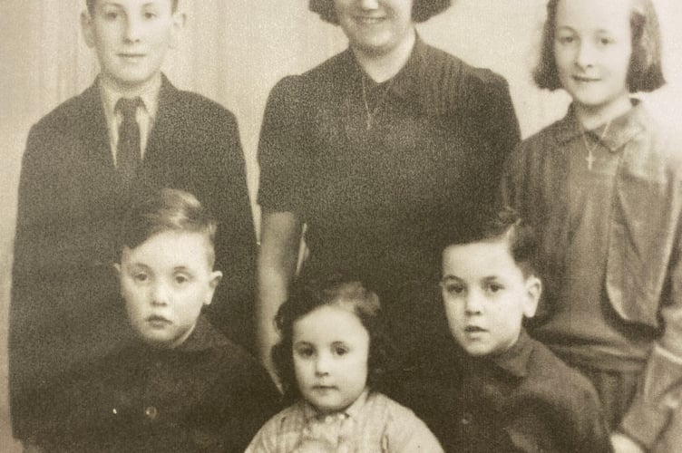 Ken Bell (front right) with his mother Eileen centre back with his brother Eddie and sister Ellen. Seated are brother Ronald and sister June. 