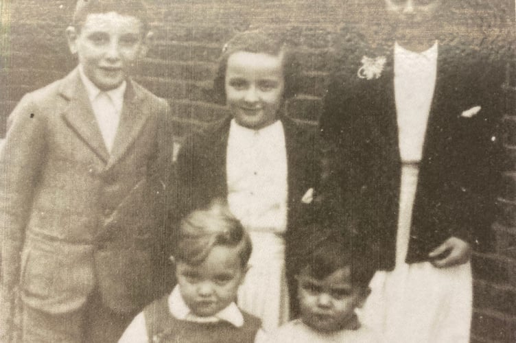 Ken Bell (front right) and his family before they were evacuated. Next to Ken is Ronald. Standing left to right brother Eddie, sister Ellen and mum Eileen