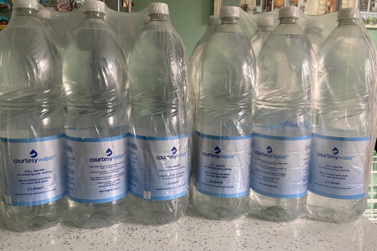 Packs of courtesy water are being handed out to customers