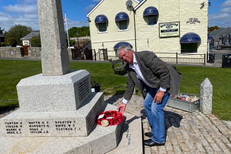 Dartmoor Forest Parish Council Chairman Mark Williams laying a wreath of remembrance at Princetown War Memorial on VE Day, followed by a two-minute silence in honour of all who gave their lives in WWII.