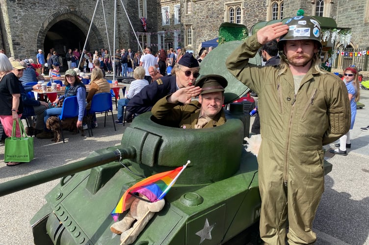 John and Paddy of the Mega Beast theatre company of street performers with their tank at Tavistock VE Day 80 party.