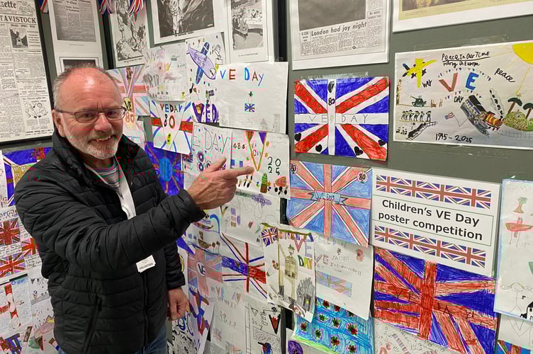 Paul Holliday, a Tavistock Museum volunteer, with the entries for the VE Day 80 primary schools poster competition.