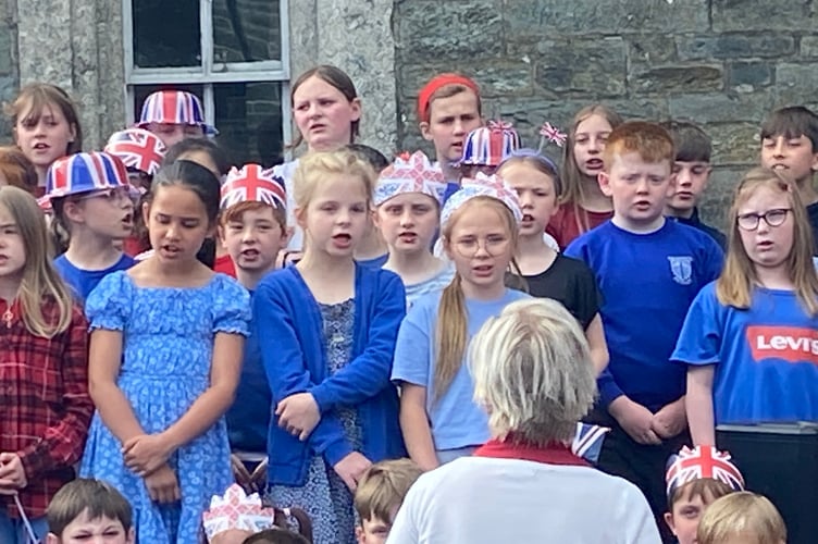Tavistock Primary entertaining crowds at Tavistock VE Day 80 commemorations.