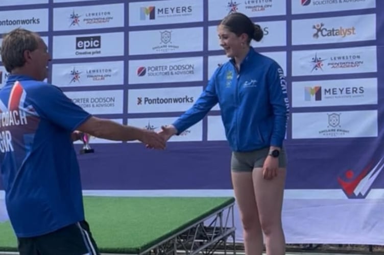 Miri, 14, of Tavistock Swimming club, receiving her third overall award in the biathlon.