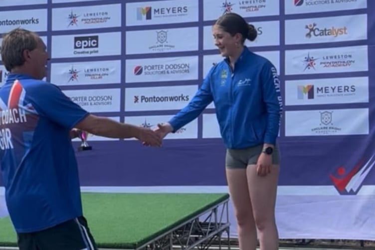 Miri, 14, of Tavistock Swimming club, receiving her third overall award in the biathlon.