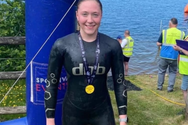 Charlotte Walker, of Tavistock Swimming Club with her gold medal at an open water meet at Roadford Lake.