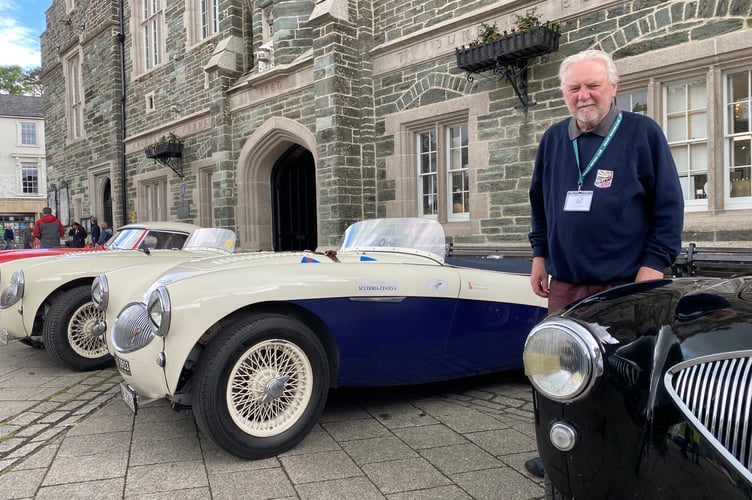 Healey Drivers Club chair Chris Selley stands proudly by his Austin Healey 100 in Tavistock's Bedford Square.