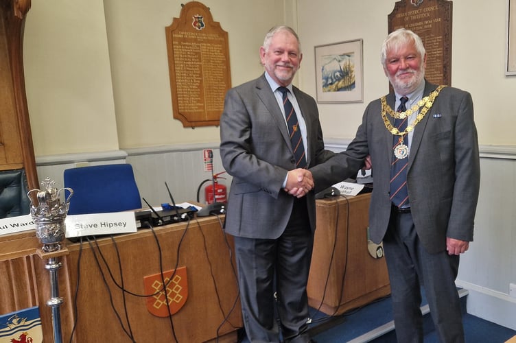 Outgoing Tavistock Mayor Paul Ward hands over the chain of office to ew Tavistock Mayor Cllr Steve Hispsey a mayor making  ceremony in the Tavistock Town Council Chamber.