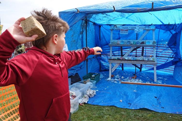 Adam Roberts enthusiastically trying to smash the china at Bere Alston Fun Day. Picture by Ann Parsons.
