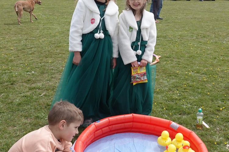 Bere Alston Fun Day. Casper Merrifield was busy trying to hook a duck, encouraged by Carnival Queen Attendants Amber Perkin and Emily Phillips. Picture by Ann Parsons.