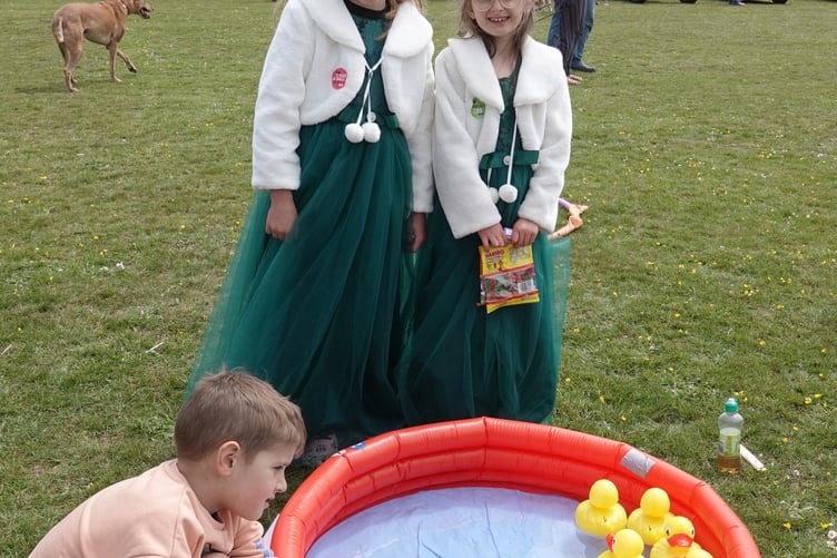 Bere Alston Fun Day. Casper Merrifield was busy trying to hook a duck, encouraged by Carnival Queen Attendants Amber Perkin and Emily Phillips. Picture by Ann Parsons.