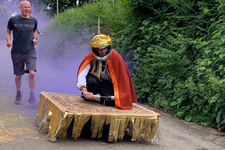 Flying carpet "Rugcruncher" gained momentum along the course followed by purple smoke and its enthusiastic team members. (Picture: Sarah Martin)