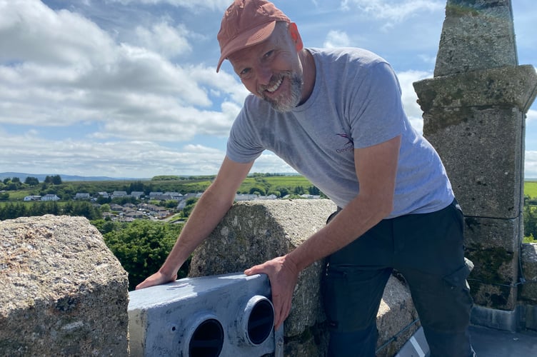 Jerry Horn, of Devon Swift Project, fitting swifts nesting boxes on top of Princetown Church tower.