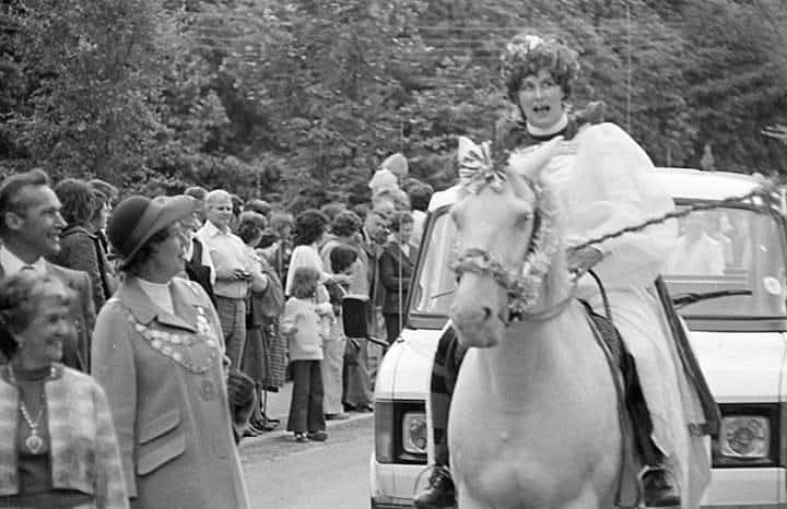 Mary riding a model horse in the carnival parade.