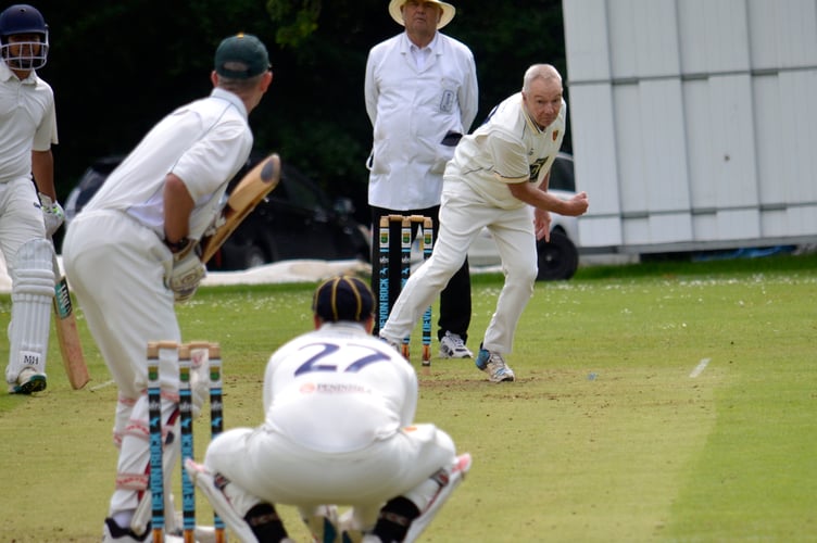 Tavistock's veteran bowler Andy Gauler – 61 and still wheeling away – coming in down the hill against Cornwood