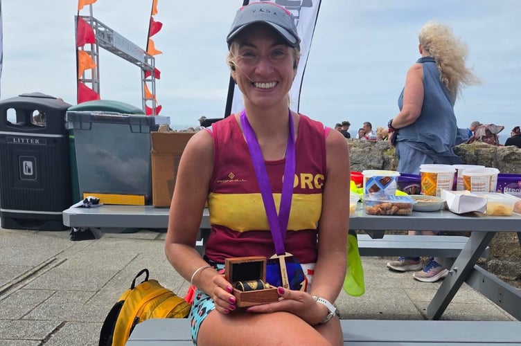 Claire Grubb with her medal after completing the Smugglers Scuttler Marathon in the far west of Cornwall.