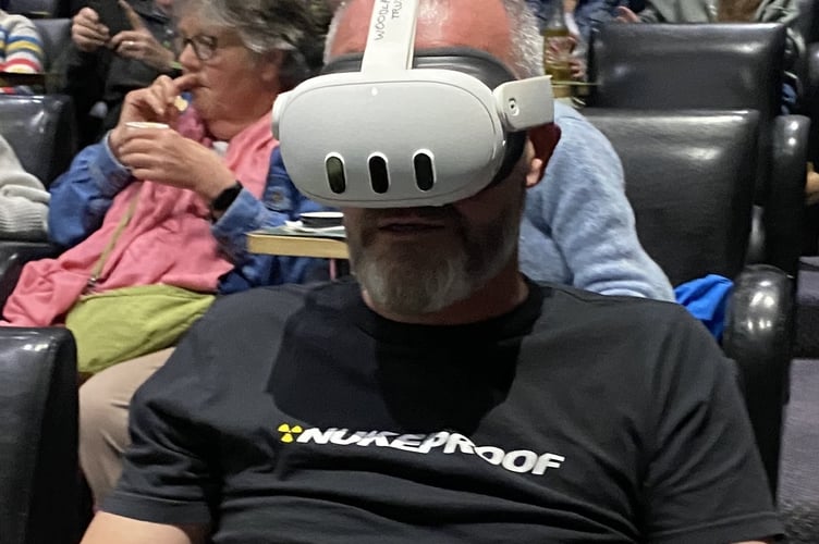 An attendee enjoying a virtual reality experience of a temperate rainforest.