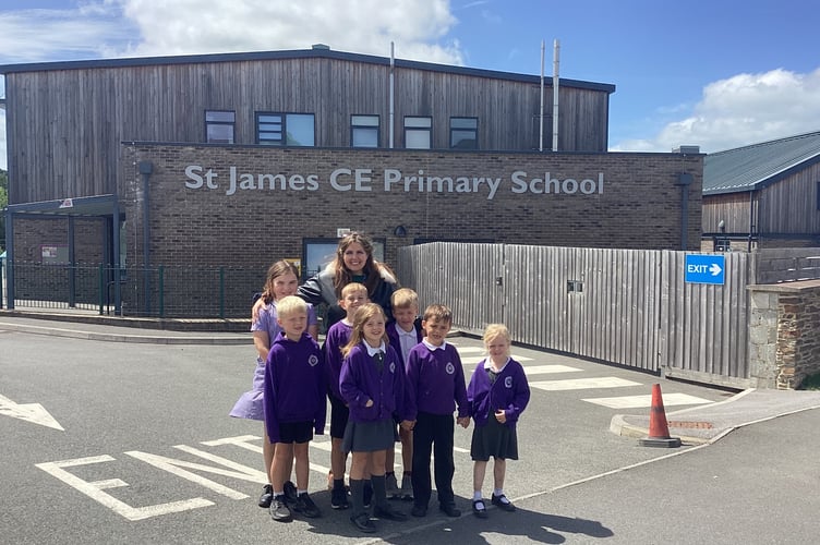 Headteacher Maria Hazelwood with some of the children outside St James Primary, Okehampton. 
