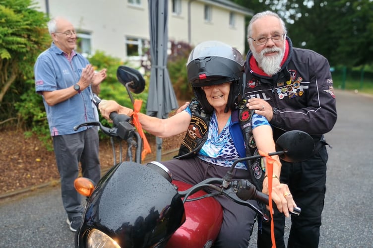 June Pearton on a Harley Davidson -loaned to make her birthday dream come true by owner Keith Finch (right). 