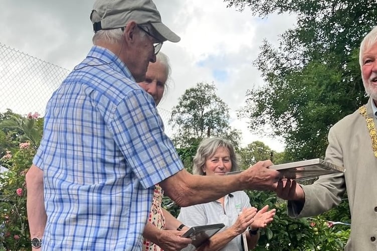 Tavistock Sensory Garden volunteer XX presented with a good service award by Tavistock Mayor Cllr Steve Hipsey at the garden's summer party.