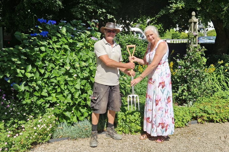 Tavistock Sensory Garden head gardener Sally Whitfield ceremonial spade handover to new head gardener Rob Smith.