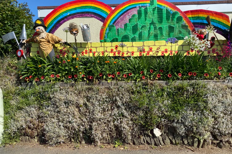 A colourful montage of the Wizard of Oz complete with scarecrow in the Bere Alston In Bloom competition.