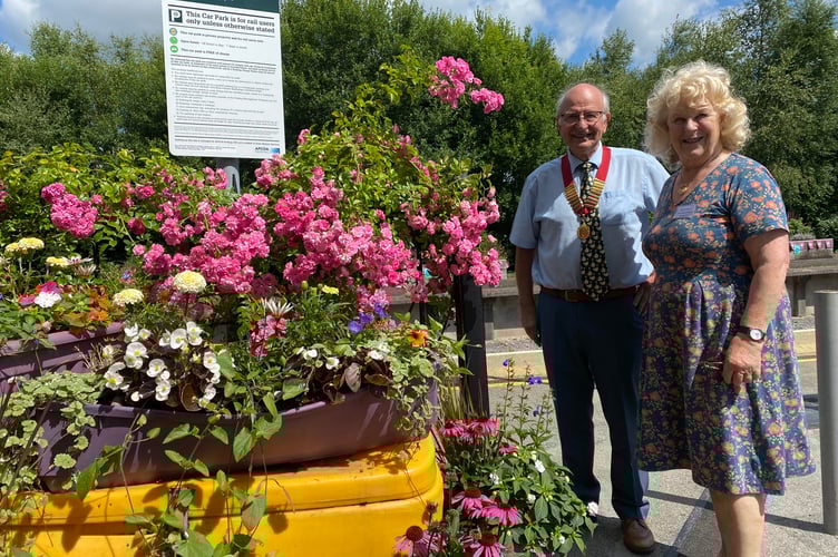 Frances Howard, environmental and sustainable member of the Bere Alston In Bloom competition with Cllr Peter Crozier of Bere Ferrers Parish Council at Bere Alston Station's competition entry.