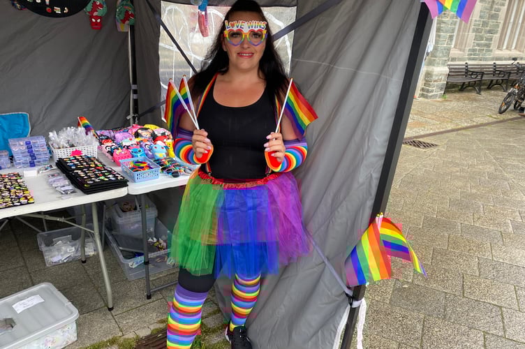 A trader at Tavi Pride showing off her colourful accessories.