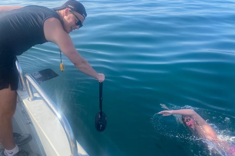 Mount Kelly College student Barnaby making good progress on his cross-Channel swim supported by a pilot boat and friends and family.
