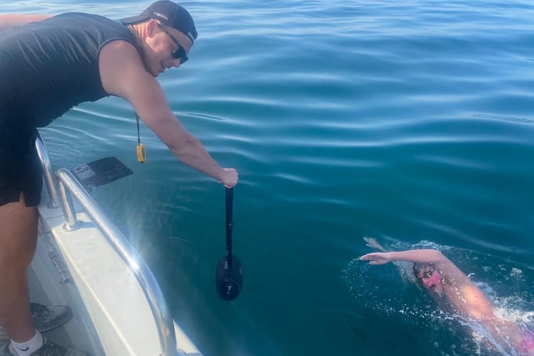 Mount Kelly College student Barnaby making good progress on his cross-Channel swim supported by a pilot boat and friends and family.