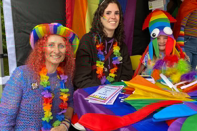 Tavistock Youth Cafe's Vicki xxx and volunteer Eloise Scaysbrook with a guest at Tavi Pride on The Meadows park.