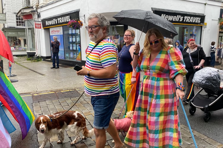 A couple and their dogs in Tavi Pride's town centre procession.