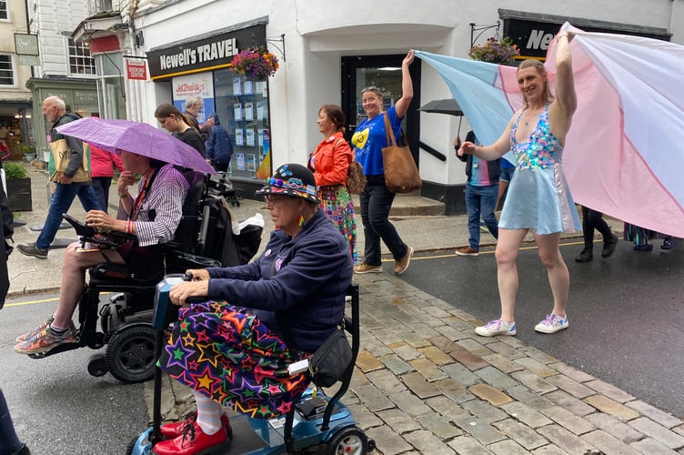 Three wheelchair riders and a drag at at Tavi Pride's town centre procession.