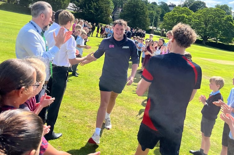 Barnaby Ryder, 17, receives a hero's welcome at Tavistock's Mount Kelly College after swimming the channel for charity.