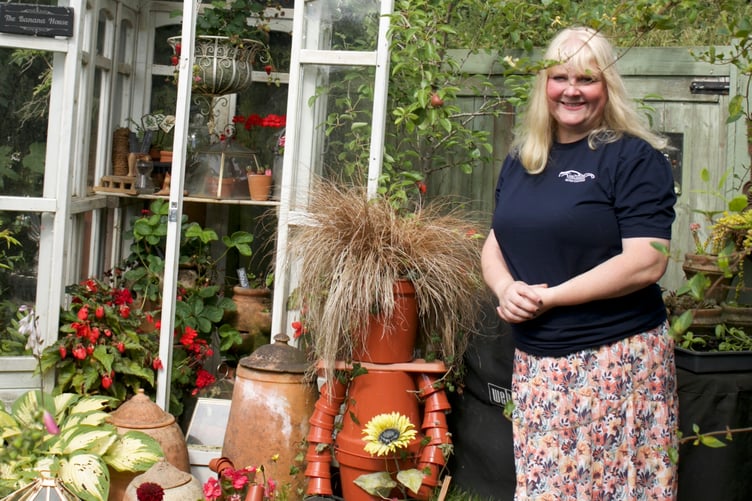 Claire White is rightly proud of  her and husband Mark's admired floral home in Lamerton which has a myriad selection of mini-gardens at the back and greenhouses.Picture by Jude Wright.