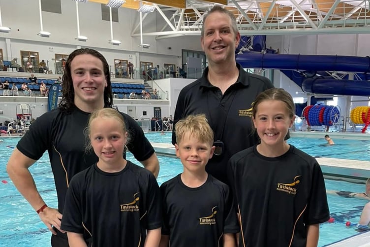 Tavistock Swimming Club youngsters make a splash at the Summer Sizzler meet at Plymouth's Life Centre.  Pictured are Lottie and  Olivia and Dom in front of coaches  XX