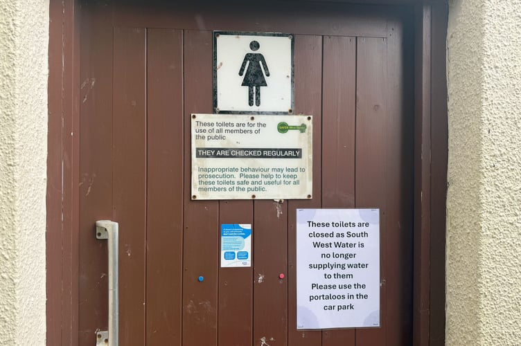 The toilets at the church with a sign that reads: "These toilets are closed as South West Water is no longer supplying water to them. Please use the portaloos in the car park"