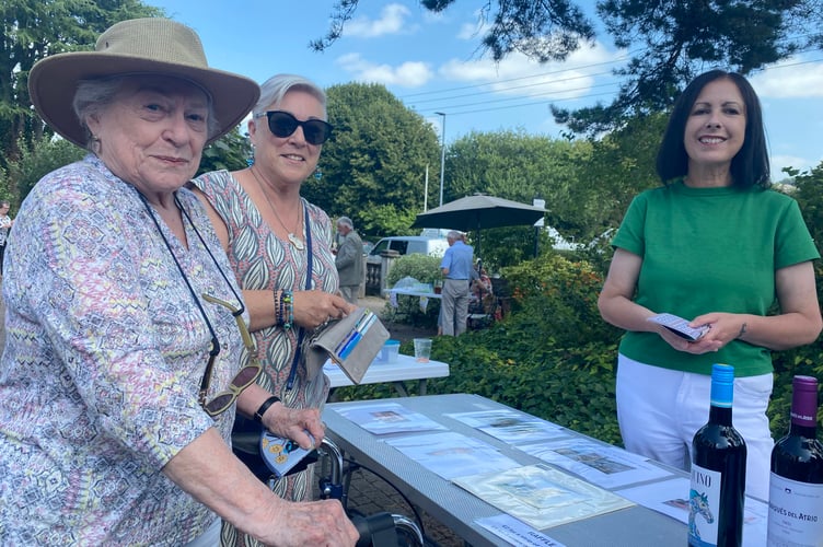 Salema Dennis (right) deputy manager of Drake Lodge, in Tavistock, selling raffle tickets at their summer fair to resident Sheila Wallace (left) and her daughter Debbie Carr.