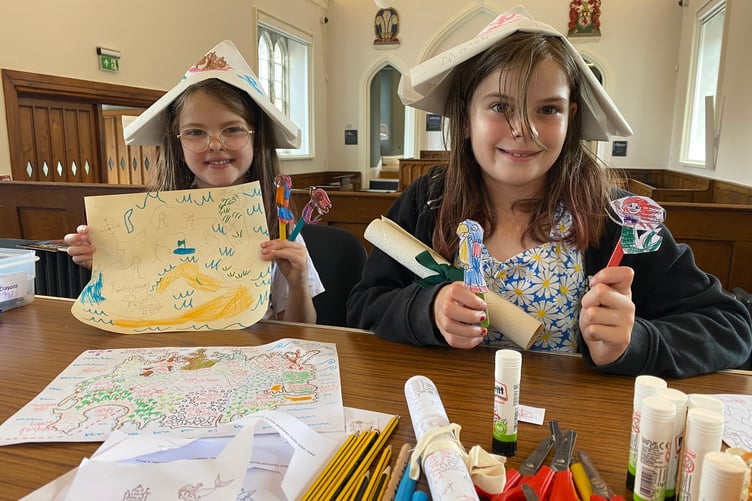 Nova, 6, and sister Eden, 10, enjoying a summer holiday pirate-themed activity at Tavistock Guildhall, courtroom