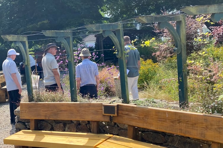 Rob Smith, head gardener at Tavistock Sensory Garden, shows Royal Horticultural Society judges the blooming delights of the community beds.
