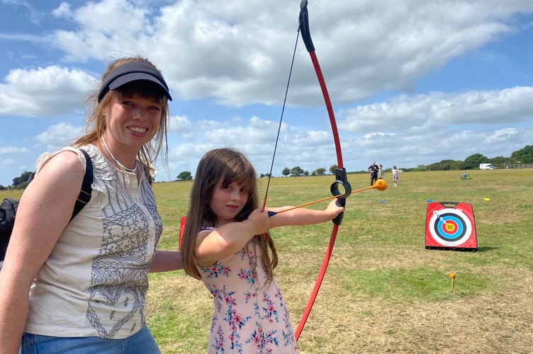 Taking aim on the archery range were Elsie Kingdon and her daughter Elsie, 6, at Yelverton Fun Day.