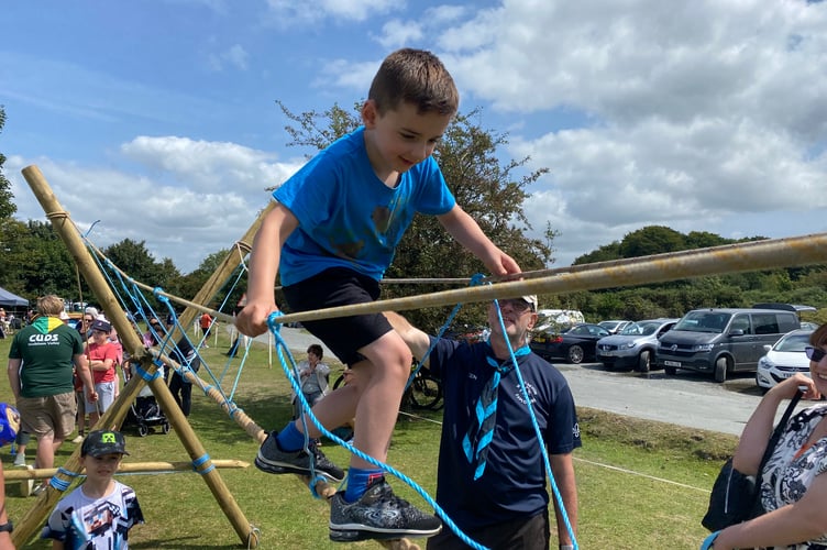 Owen Murphy, 6, tackles the wobbly rope bridge made by Walkham Valley and Horrabridge Scouts at Yelverton Fun Day. Owen lost confidence half way along and had to be helped down.