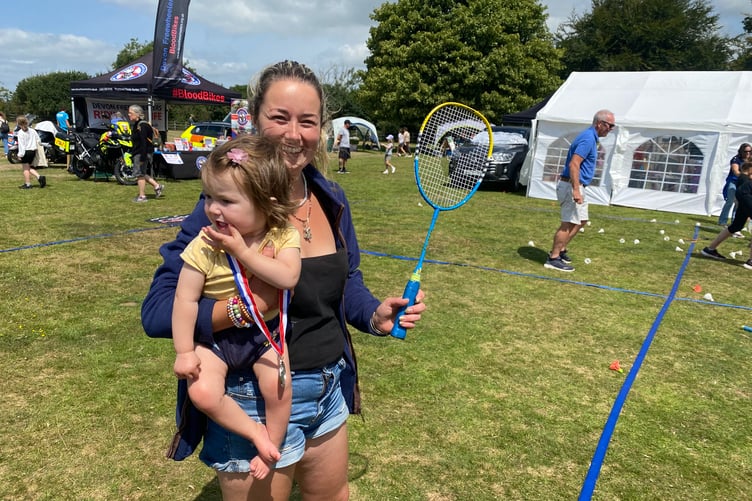 Millie French shows her daughter Lilly-May, 5, the basics of badminton at Yelverton Fun Day where she spent the morning with her other children.